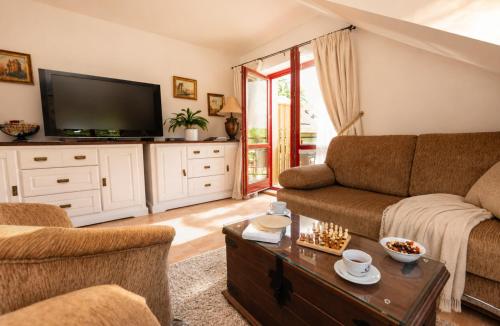 a living room with a couch and a tv at Apartmány Sonáta Luhačovice in Luhačovice