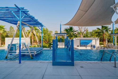 a playground in a pool with a swing at Santorini check in in Ras al Khaimah