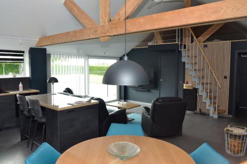 a living room with a table and some chairs at Horizon d'or in Profondeville