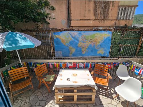 a table and chairs with a map of the world at Hostel Budva in Budva