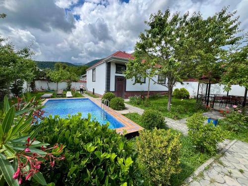 a house with a swimming pool in a yard at Gabala White House in Gabala