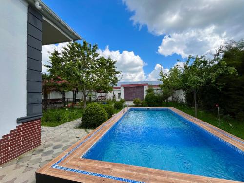 a swimming pool in the backyard of a house at Gabala White House in Gabala