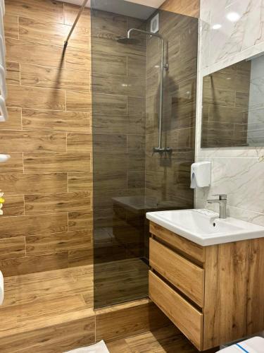 a bathroom with a sink and a shower at Готель River House in Uman