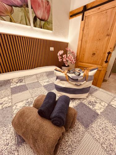 a bathroom with two towels and a vase with flowers at Tati's Home CHARME & BIKERS in Mandello del Lario