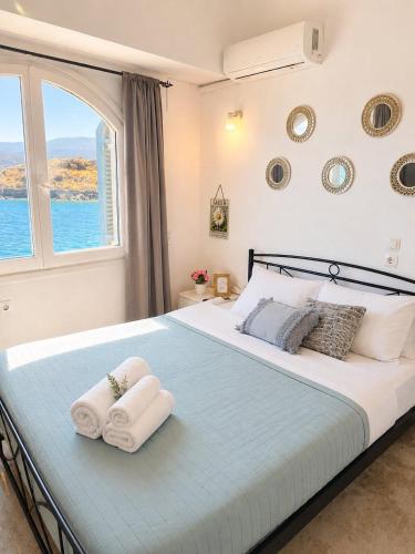 a bedroom with a large bed with towels on it at Horn Agios Nikolaos in Agios Nikolaos