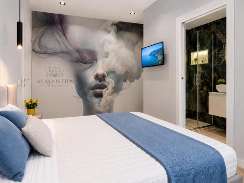 a bedroom with a large poster of a woman with smoke at Almantra Rooms - Valle dei Templi e Mare in Favara