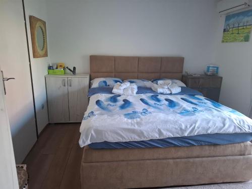 a bedroom with a bed with two dolls on it at Radovići,Luštice in Radovici