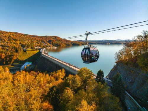 a gondola ride over a lake in the fall at Apartamenty Solina 67 in Solina