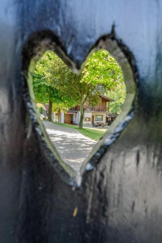 a heart shaped hole in a wall with a tree at Paradise Glamping in Saint Vincent