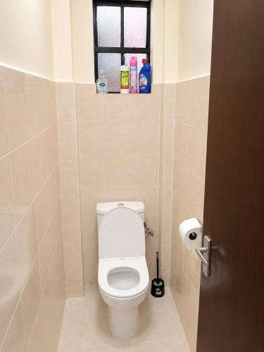 a bathroom with a toilet and a window at Fahari House in Embu