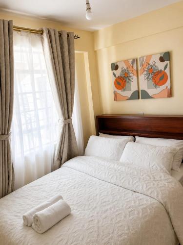 a bedroom with a bed with a towel on it at Fahari House in Embu