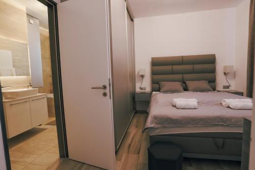 a bedroom with a bed and a bathroom with a sink at Casa Calma in Esztergom