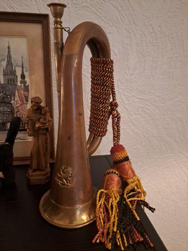 an old kettle sitting on a table next to a wall at The Carmelite in Ieper