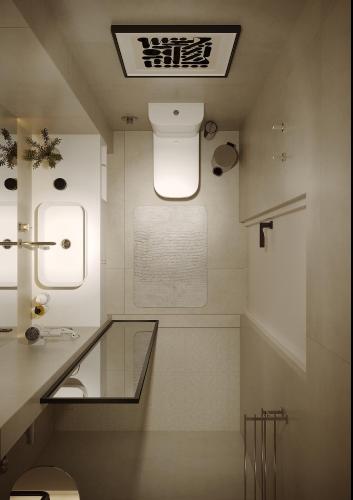 a bathroom with a toilet and a glass counter at Carlton Hotel Tashkent in Tashkent