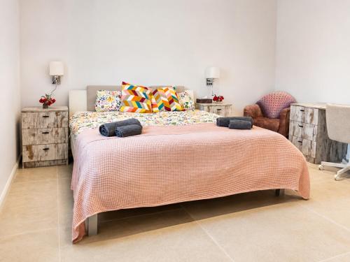 a bedroom with a bed with a blanket and a chair at Casa Era Canaria in Arona