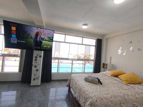 a bedroom with a large screen in the wall at Apartamentos "APPART D'ELIETTE" in Trujillo