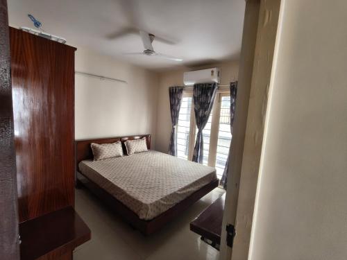 a small bedroom with a bed and a window at 2bhk furnished Richmond town in Bangalore