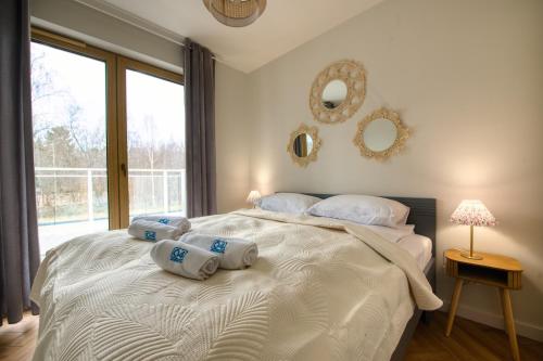 a bedroom with a bed with two pillows on it at Łebska Osada- basen, parking in Żarnowska