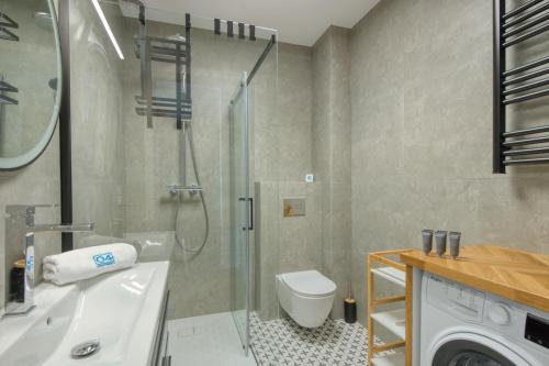 a bathroom with a shower and a toilet and a sink at Łebska Osada- basen, parking in Żarnowska