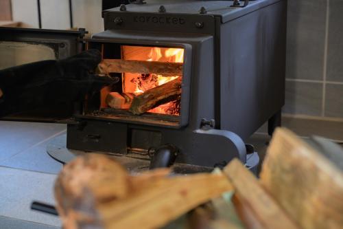 a person is putting food into an oven at 高野神谷宿 一結 in Koyasan