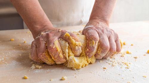 a person with their hands on a table with food at B&B Hotel Villa Nora in Bellaria-Igea Marina