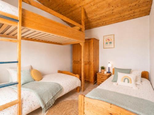 two bunk beds in a room with wooden ceilings at Eco Casa Branca in nature - hidden, unique paradise in Aljezur