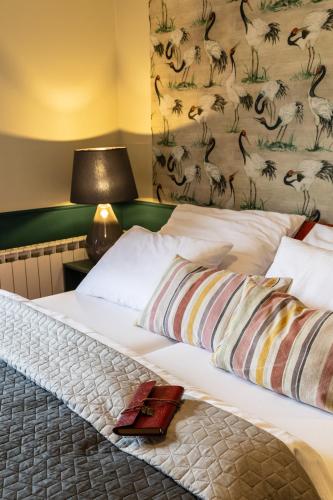 a bed with white sheets and pillows in a room at Apartmány Sonáta Luhačovice in Luhačovice