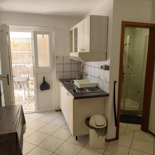 a kitchen with a sink and a counter top at Apartments Ada in Primošten