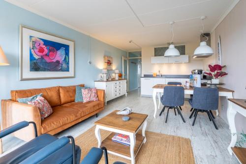 a living room with a couch and a table at Appartementencomplex Juliana 148 in De Koog