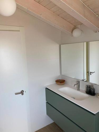 a bathroom with a sink and a mirror at La Llarena in La Isla