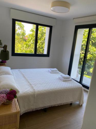 a bedroom with a bed with two towels on it at La Llarena in La Isla