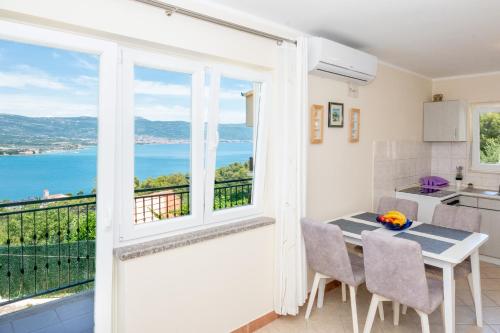a kitchen and dining room with a view of the ocean at Blue Horizon Retreat in Trogir