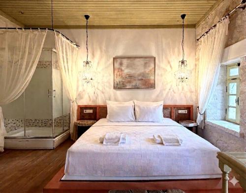 a bedroom with a bed with two towels on it at Marge Hotel Adult Only 12 plus in Ilıca