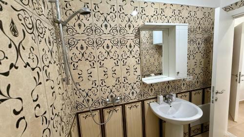 a bathroom with a sink and a mirror at EG Beach Apartments 105A in Lezhë