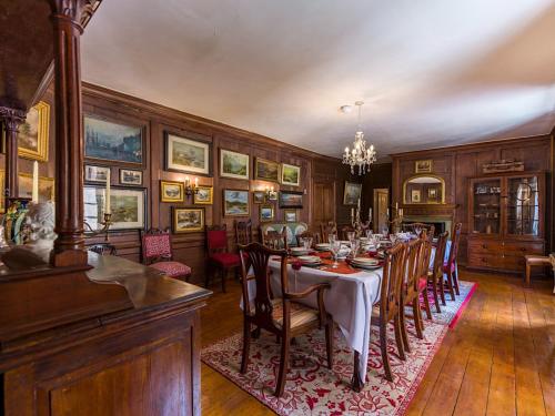 a dining room with a long table and chairs at Lickleyhead Castle in Insch
