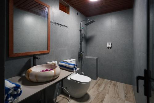 a bathroom with a toilet and a sink with a shower at Valley Palm Seaview in Guraidhoo