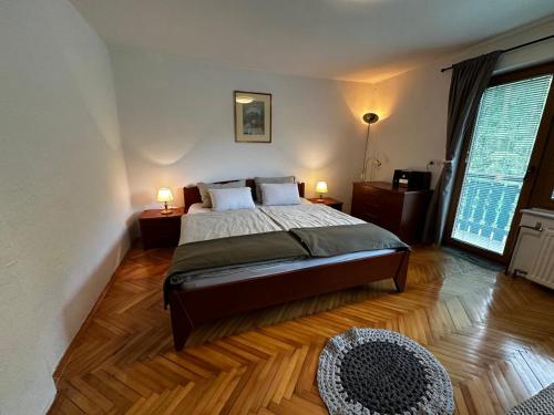 a bedroom with a bed and a large window at Hiša Jezersko in Zgornje Jezersko