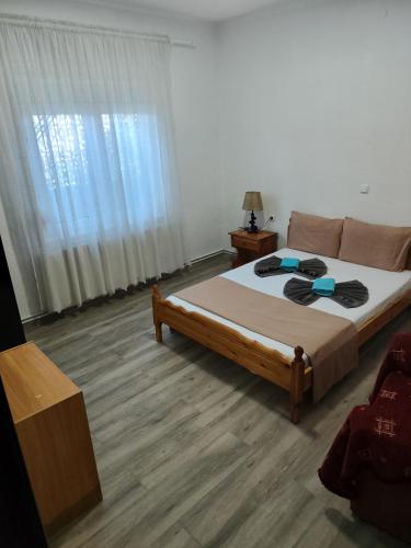 a bedroom with a large bed and a window at Xaris House in Ávaton