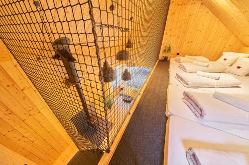 a bird cage with four beds in a room at Glamping KOLBENKA in Horní Malá Úpa