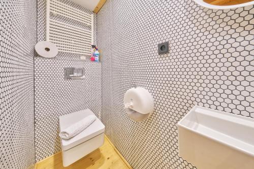 a bathroom with a white toilet and a sink at Glamping KOLBENKA in Horní Malá Úpa