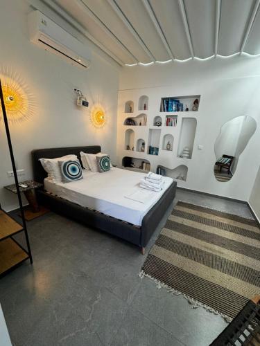 a bedroom with a bed and a lamp and a rug at Olvion Luxury Living in Kallithea Halkidikis