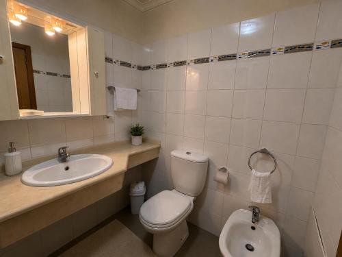 a bathroom with a toilet and a sink at Cantinho de Santa Teresa in Canhas