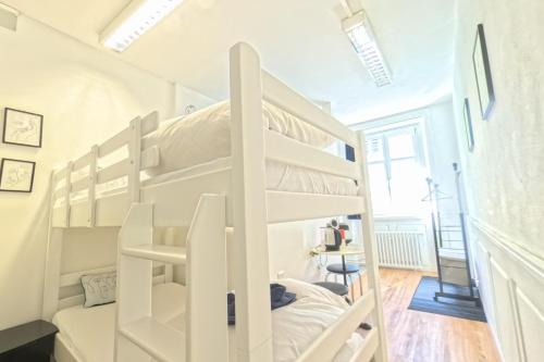 a white bunk bed in a small room at Haus zum Rütli in Chur