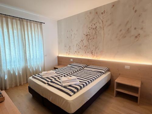 a bedroom with a large bed with a window at Bastian B&B in Sarmede