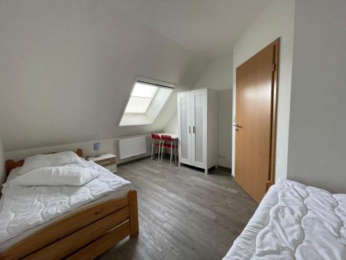 a bedroom with two beds and a window at Am Wangermeer 38 in Wangerland