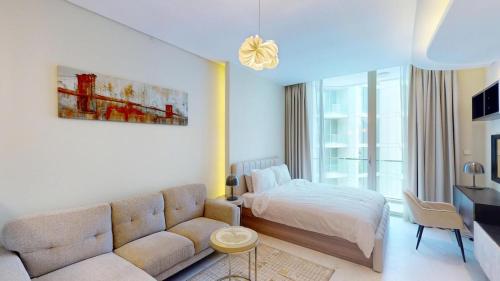 a living room with a bed and a couch at Bahrain Bay Retreat Studio in Manama