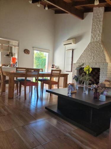 a living room with a table and a fireplace at BAHIA BLANCA-BARRIO PARQUE in Bahía Blanca