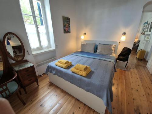 a bedroom with a bed with two towels on it at House in Kamares - Sifnos in Kamares