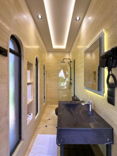 a bathroom with a black sink and a window at Just V hotel & Spa in Marrakesh