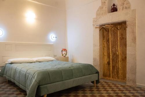 a bedroom with a bed and a fireplace at Pepenero Apulian Rooms in Noci